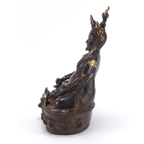 385 - Chino Tibetan partially gilt bronze figure of Buddha with a rat, 31cm high