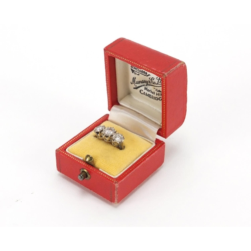 650 - 18ct white gold diamond three stone ring, housed in a Munsey & Co leather box, London 1973, size N, ... 