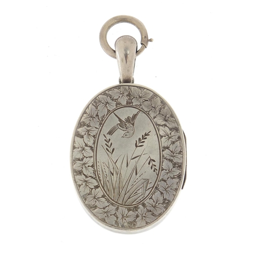 648 - Victorian Aesthetic unmarked silver locket engraved with a bird amongst reeds, 6cm in length, 23.0g