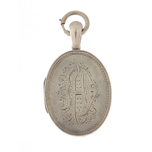 648 - Victorian Aesthetic unmarked silver locket engraved with a bird amongst reeds, 6cm in length, 23.0g