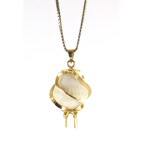 687 - Coconut pearl pendant with gilt metal mounts on a silver gilt necklace, the pendant 3.5cm in length,... 