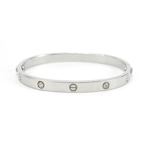 647 - ** WITHDRAWN ** 18ct white gold bangle set with clear stones, housed in a Cartier tooled leather box... 