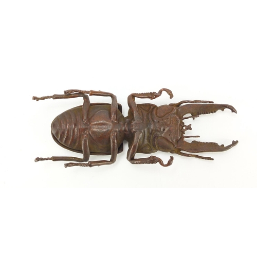 402 - Japanese patinated bronze stag beetle with articulated wings, impressed marks to the underside, 13cm... 