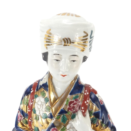 393 - Japanese porcelain figurine of a girl holding a basket, 33cm high