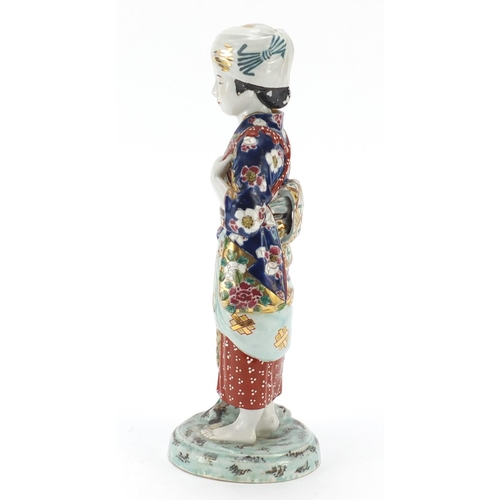 393 - Japanese porcelain figurine of a girl holding a basket, 33cm high