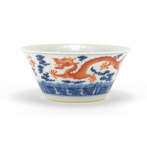 336 - Chinese blue and white porcelain bowl, hand painted in iron red with dragons amongst clouds chasing ... 