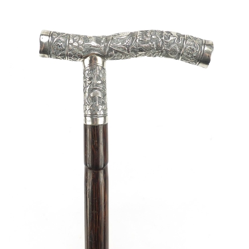 106 - Bamboo walking stick with Indian unmarked silver handle embossed with village scene, engraved John C... 