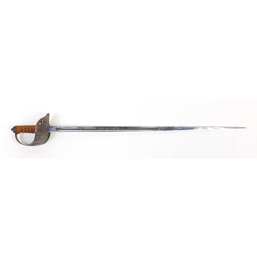 275 - British Military dress sword with scabbard, the steel blade engraved with Regimental motifs, 103cm i... 