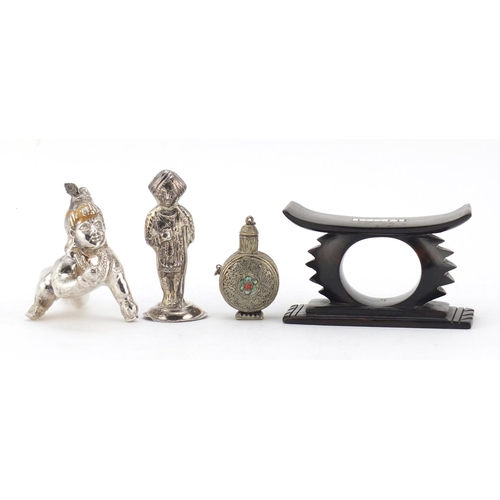 614 - Two unmarked silver Indian figures, a Tibetan scent bottle and African head rest, the largest 10cm i... 