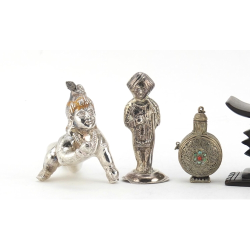 614 - Two unmarked silver Indian figures, a Tibetan scent bottle and African head rest, the largest 10cm i... 