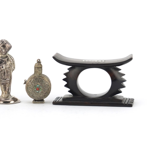 614 - Two unmarked silver Indian figures, a Tibetan scent bottle and African head rest, the largest 10cm i... 