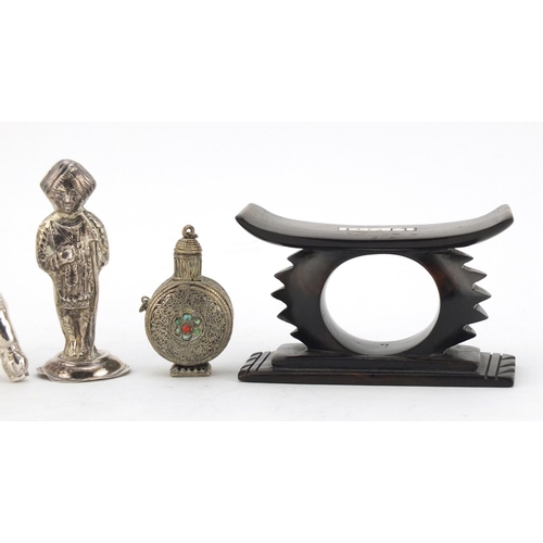 614 - Two unmarked silver Indian figures, a Tibetan scent bottle and African head rest, the largest 10cm i... 