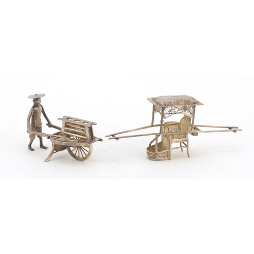 630 - Chinese silver model of a figure pushing a cart and a filigree metal carriage, the largest 11cm in l... 