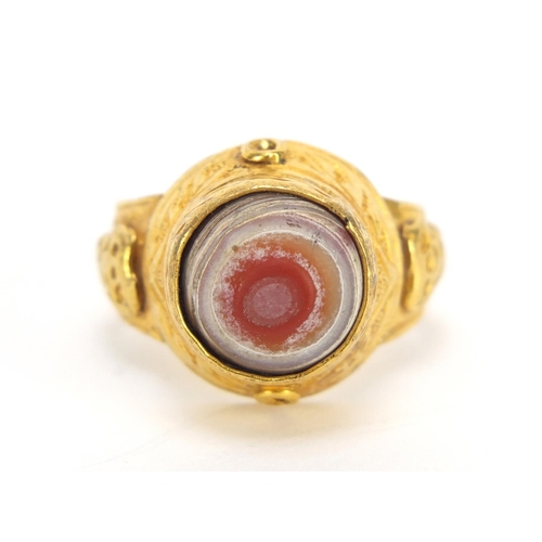 677 - Islamic gilt metal antique style ring set with a hand painted cabochon stone, size R, 7.0g