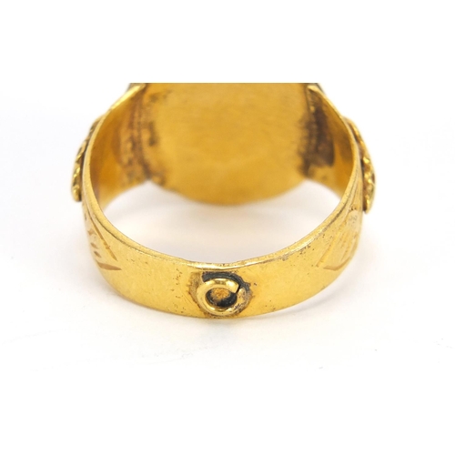 677 - Islamic gilt metal antique style ring set with a hand painted cabochon stone, size R, 7.0g