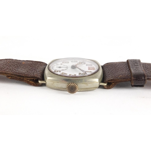 706A - Two Military interest trench watches, one with silver case, each with luminous hands and dial, the l... 