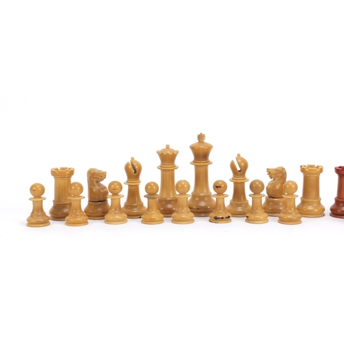 128 - Carved vegetable ivory half stained chess set, the largest piece 9cm high