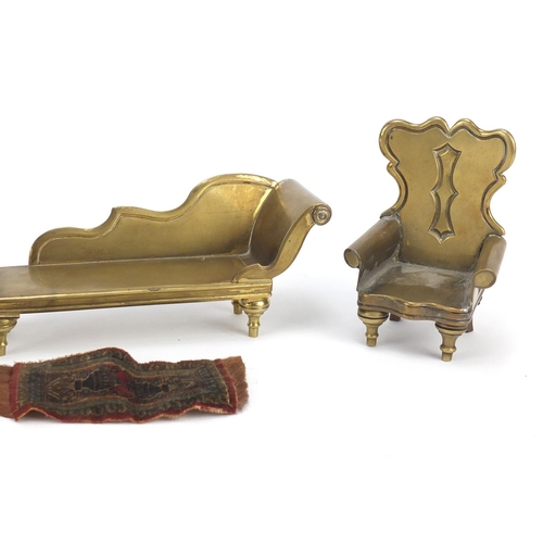 13 - Antique brass dolls house furniture and a rug comprising two chairs and a chaise lounge, the largest... 