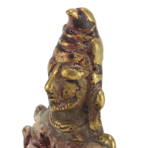 188 - Tibetan bronzed figure of a praying to a God, 16cm high