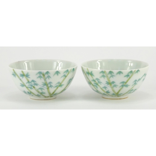 311 - Pair of Chinese porcelain bowls hand painted with bamboo, character marks to the bases, each 9cm in ... 