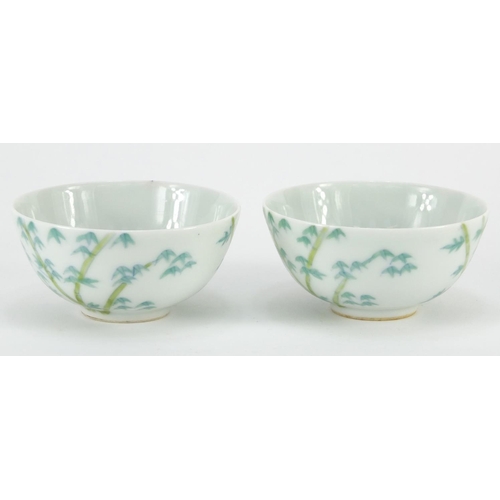 311 - Pair of Chinese porcelain bowls hand painted with bamboo, character marks to the bases, each 9cm in ... 