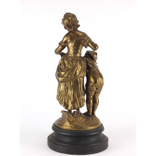 242 - Gilt Spelter figure of a mother and boy with a chick, raised on a circular ebonised base, 37cm high