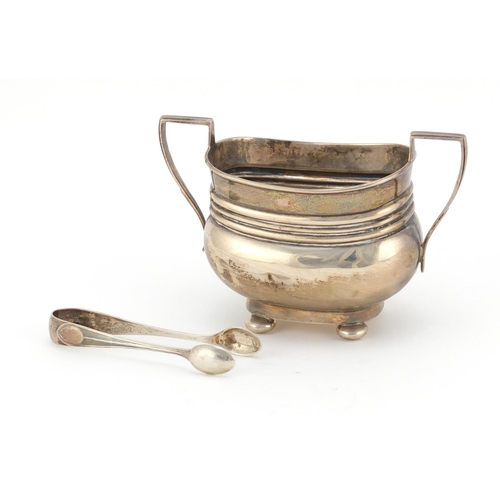 600 - Silver twin handled sugar bowl with ball feet and a pair of silver sugar tongs, Birmingham and Sheff... 