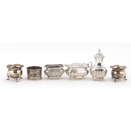 599 - Silver cruet items and a circular silver napkin ring, various hallmarks, the largest 8.5cm high, 235... 