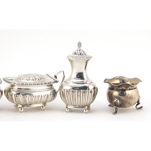 599 - Silver cruet items and a circular silver napkin ring, various hallmarks, the largest 8.5cm high, 235... 