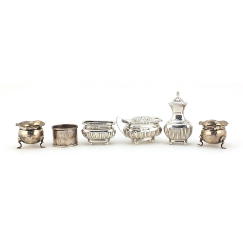 599 - Silver cruet items and a circular silver napkin ring, various hallmarks, the largest 8.5cm high, 235... 