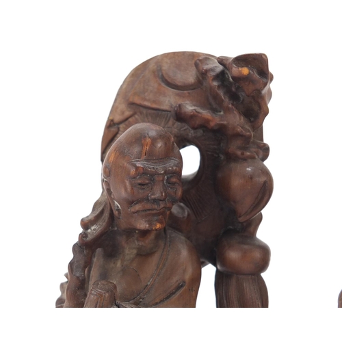 399 - Two Chinese root carvings of elders, the largest 21cm high