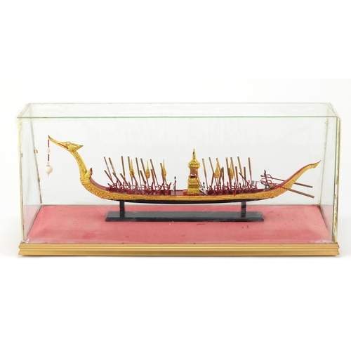 250 - Hand painted gondola boat under a glass display case, overall 52cm in length