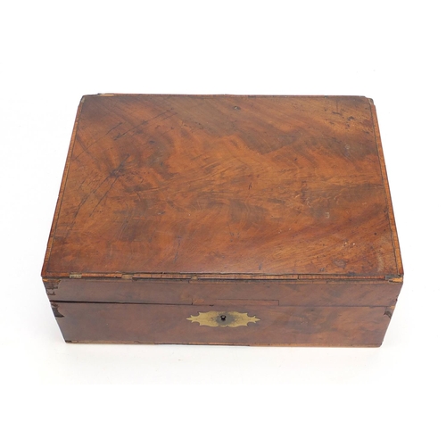 72 - Victorian cross banded walnut writing box with fitted leather interior, having silver coloured mount... 