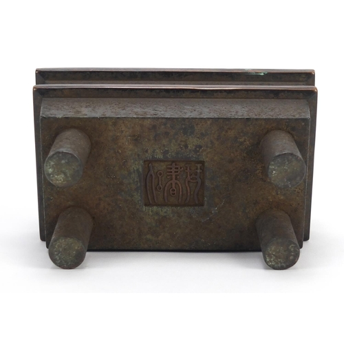 381 - Chinese patinated bronze four footed incense burner with twin handles, character marks to the base, ... 