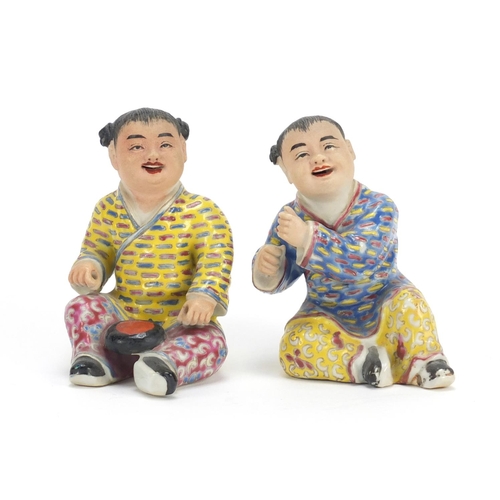 335 - Pair of Chinese hand painted porcelain figures of children, the largest 10cm high