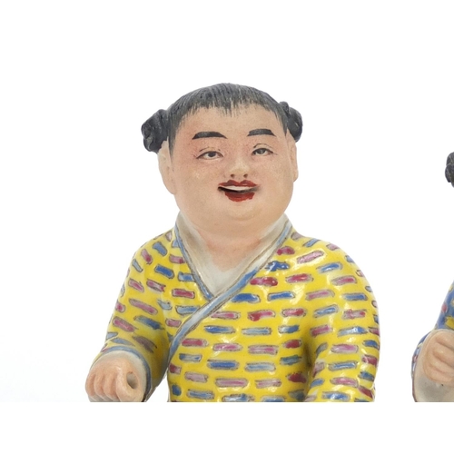 335 - Pair of Chinese hand painted porcelain figures of children, the largest 10cm high