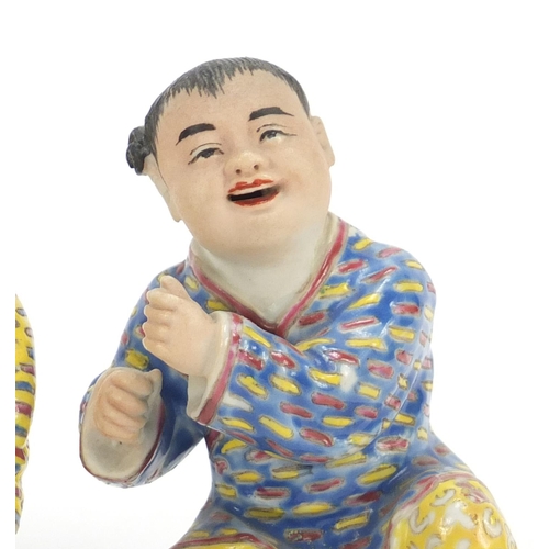 335 - Pair of Chinese hand painted porcelain figures of children, the largest 10cm high