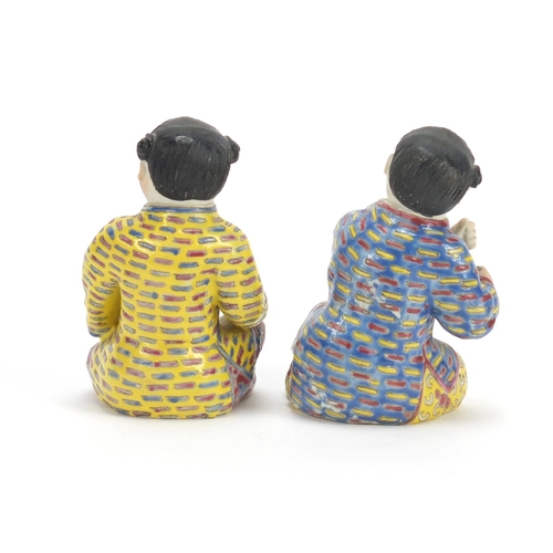 335 - Pair of Chinese hand painted porcelain figures of children, the largest 10cm high