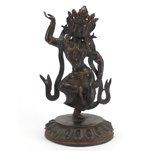 378 - Chino Tibetan partially gilt bronze figure of a jewelled deity, 42cm high