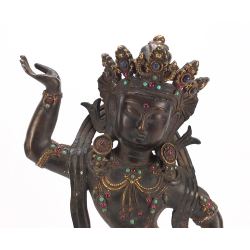 378 - Chino Tibetan partially gilt bronze figure of a jewelled deity, 42cm high