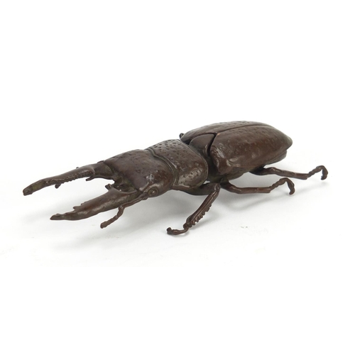 401 - Japanese patinated bronze stag beetle with articulated wings, character marks to the underside, 13.5... 