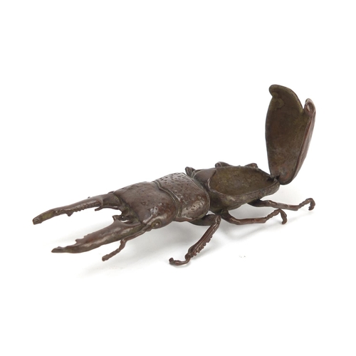 401 - Japanese patinated bronze stag beetle with articulated wings, character marks to the underside, 13.5... 