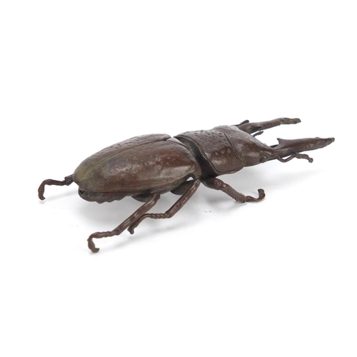 401 - Japanese patinated bronze stag beetle with articulated wings, character marks to the underside, 13.5... 