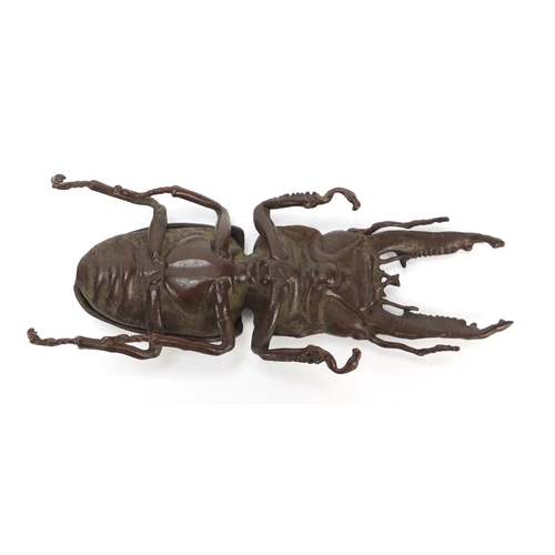 401 - Japanese patinated bronze stag beetle with articulated wings, character marks to the underside, 13.5... 