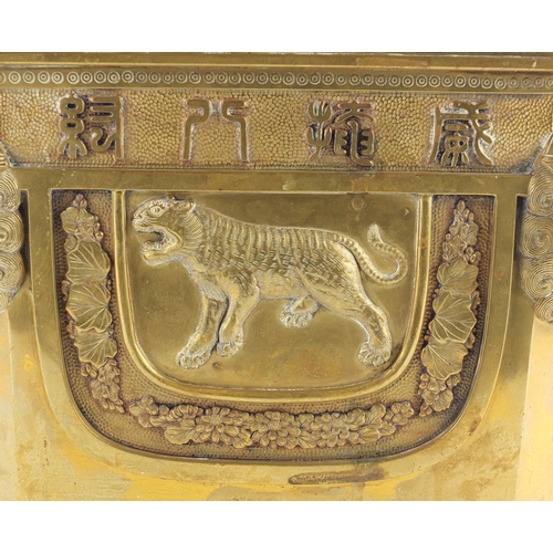 379 - Chinese bronze planter with lion head handles, finely cast panels of animals and calligraphy, charac... 