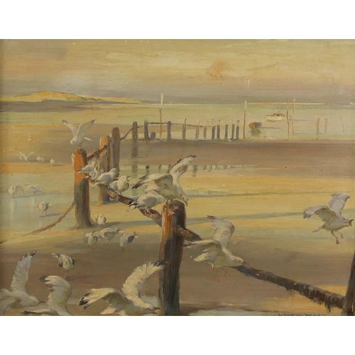 896 - Vernon Ward 1933 - Beach scene with seagulls and moored boats, oil on board, label verso, framed, 35... 