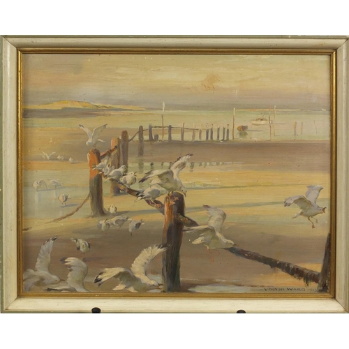 896 - Vernon Ward 1933 - Beach scene with seagulls and moored boats, oil on board, label verso, framed, 35... 