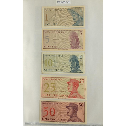 203 - Album of world bank notes arranged in an album including China, Austria, Cambodia and Germany