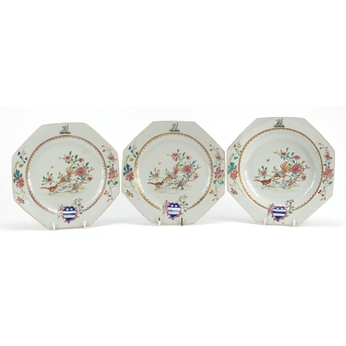 307 - Two Chinese porcelain armorial plates and a soup bowl, each finely hand painted in the famille rose ... 