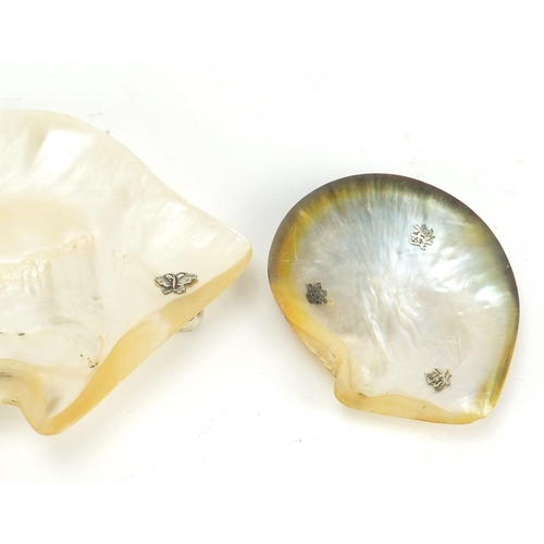 422 - Three Chinese mother of pearl shell dishes with unmarked silver feet, the largest 19.5cm wide
